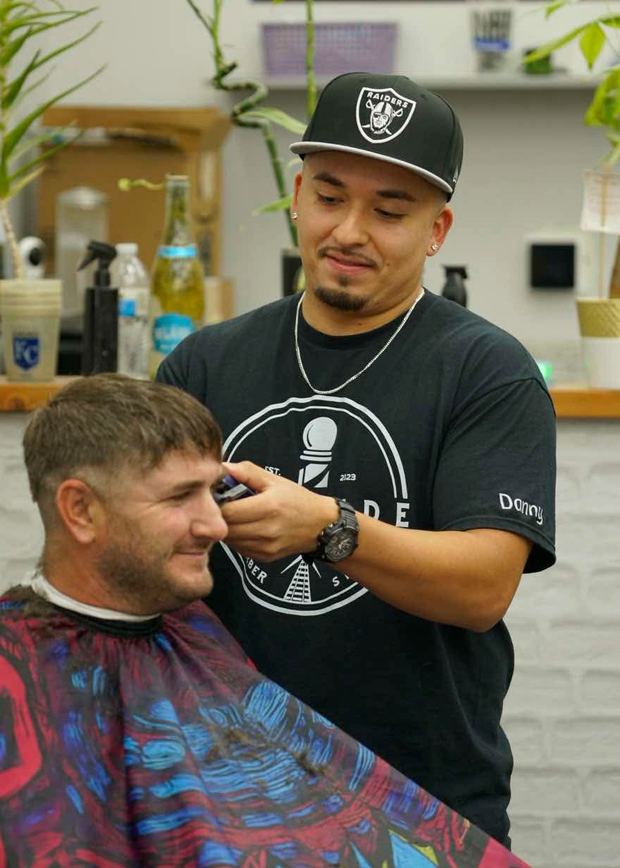 Danny Trevino cutting a client's hair at Railside
